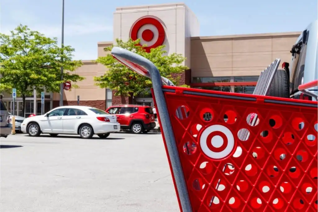 Red shopping cart and parked cars in the foreground with a Target store in the background—Get $35 to Shop at Target FREE!