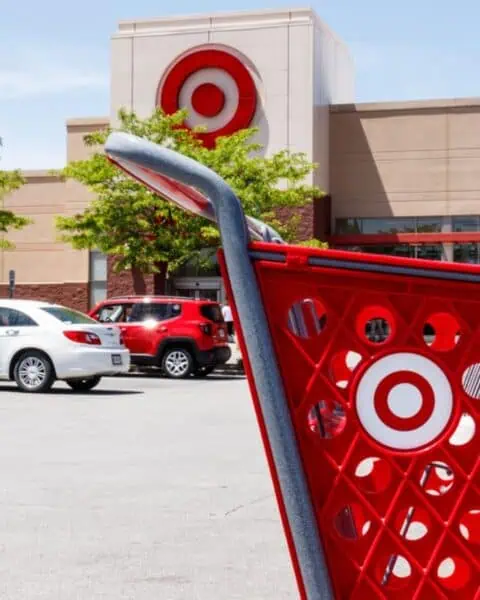 Red shopping cart and parked cars in the foreground with a Target store in the background—Get $35 to Shop at Target FREE!