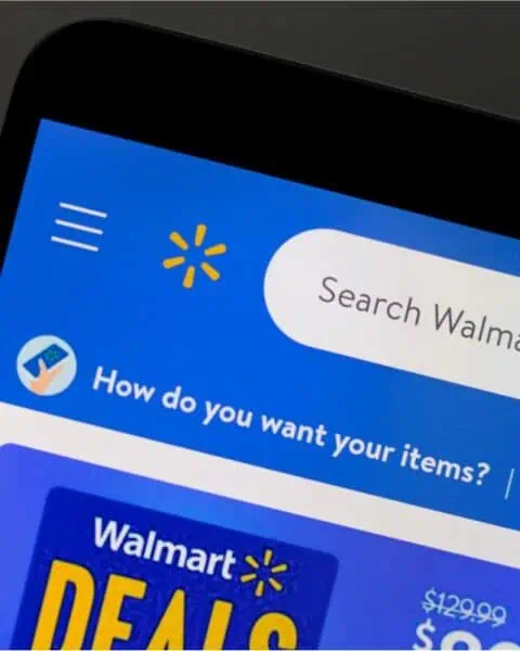 A digital device showcasing the Walmart app interface highlights a search bar and a section for promotional deals, including options to shop free with special offers.