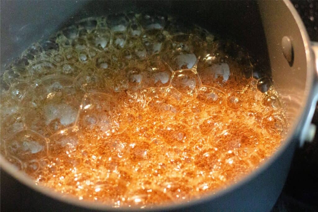 Close-up of delicious caramel bubbling in a pot, showcasing the magic of an easy homemade caramel recipe.