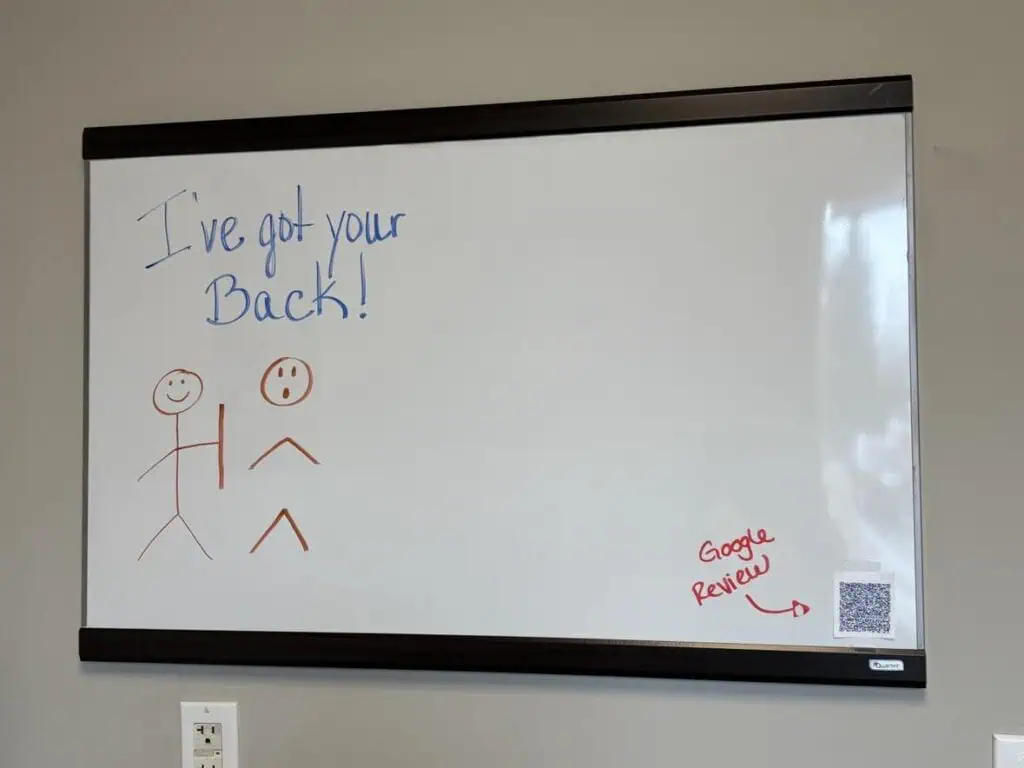 On a personal post, a whiteboard displays a sketch of two stick figures—one holding a stick labeled "I've got your back!" A QR code and "Google Review" feature prominently in the bottom right corner.