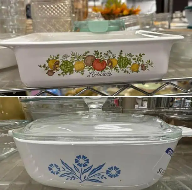 Two vintage casserole dishes on a shelf: the top one has a fruit and vegetable pattern, and the bottom one features a blue floral design, both with glass lids.