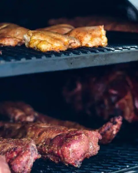Chunks of meat slowly sizzle inside the smoker, with chicken gracing the top rack and ribs below. This age-old technique not only infuses flavor but also offers a way to preserve meat without a refrigerator, capturing the essence of traditional storage methods.