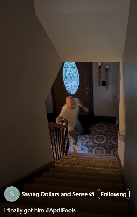A person in a white shirt and blue jeans is running up a dimly lit staircase towards the camera. A patterned rug adds character behind them, while the closed door with an oval glass window allows a sliver of sunshine to peek through.