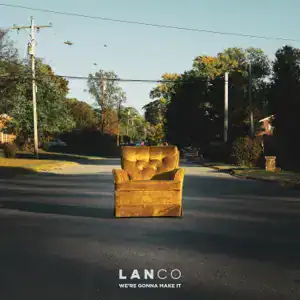 A yellow armchair sits in the middle of an empty suburban street, surrounded by trees and houses under a clear sky. Amid the calm chaos, text at the bottom reads "LANCO We're Gonna Make It.
