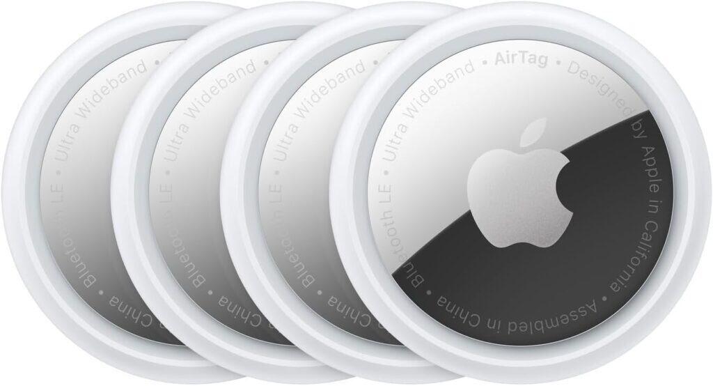 Four Apple AirTags are arranged in an overlapping row, each featuring a white outer rim and the Apple logo in the center—perfect for learning about Apple AirTag uses and maximizing their potential.