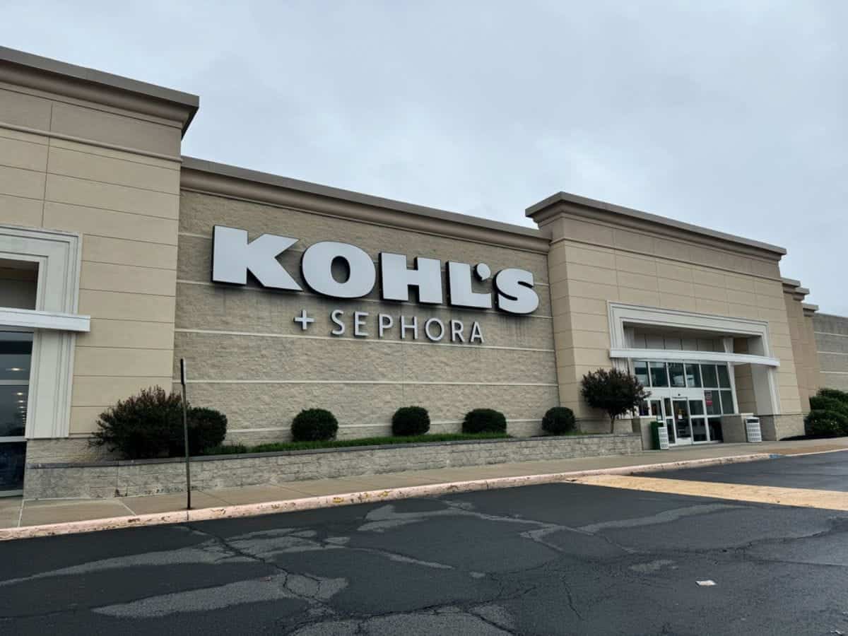 Exterior of a Kohl’s store with Sephora signage, beige facade, glass entrance doors, cloudy sky, and an empty parking lot—perfect for stopping by to enjoy Kohls Rewards benefits on your next visit.