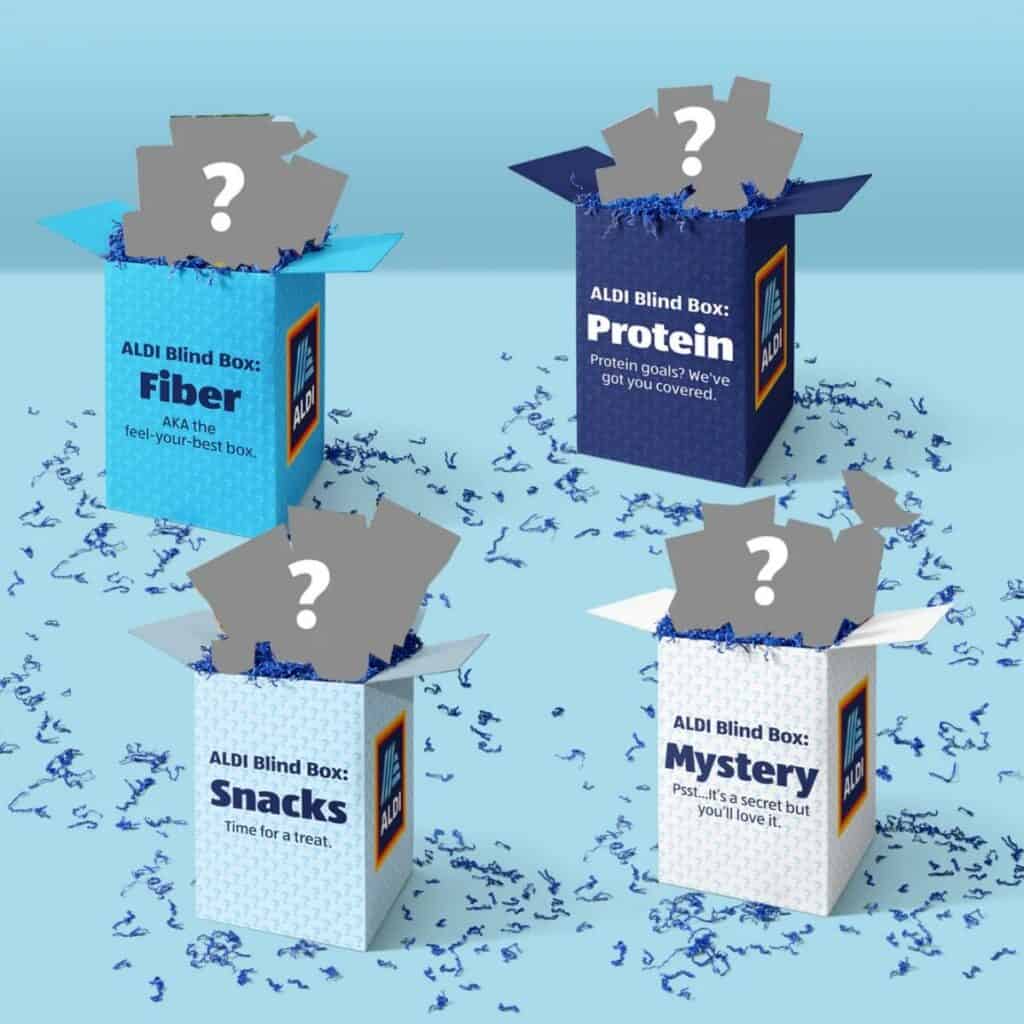 Four blue ALDI Blind Boxes labeled "Fiber," "Protein," "Snacks," and "Mystery" from Aldi, each hiding a question-marked treat inside, surrounded by blue confetti—discover surprises and maybe score free groceries with exciting ALDI promotions.