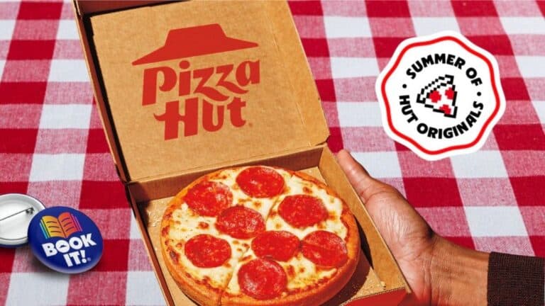 A hand holding an open Pizza Hut box with a small pepperoni pizza inside, on a red and white checkered tablecloth, with "Summer of Hut Originals," "Book It!" items, and a Free Pizza offer nearby.