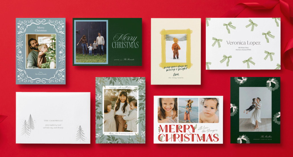 Eight Christmas cards and envelopes tied with a ribbon, arranged neatly on a solid red background.